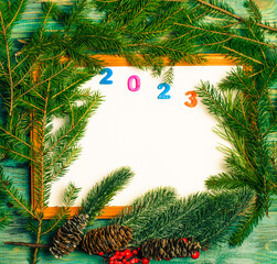 Wall Mural - Christmas wooden background with fir branches and a place to copy.