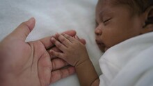 Parent Hands Holding Newborn African Black Baby Fingers, Close Up Mother's Hand Holding Their New Born Baby. Together Love Family Healthcare And Medical, Father's Day And Mother's Day Concept