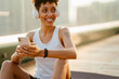 © Drobot Dean - Black young woman smiling during yoga practice on rooftop