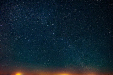 Poster - Amazing starry sky over city yellow lights. Space background with free copy space for design