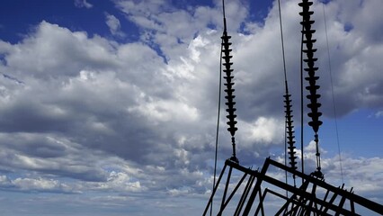 Wall Mural - Electricity pylon (high voltage power line), black contour, on the background of the cloudy sky (time lapse) 