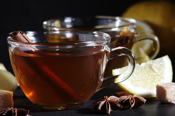 Two glass cups with hot tea with lemon and ginger