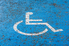 Graphic Printed On Asphalt With White And Blue Colors To Notice Disabled Parking Lot