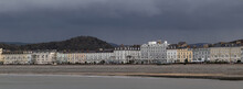 Banner With A View Of A Seaside Town And A Dark Sky During The Rain. Llandudno, Wales, United Kingdom