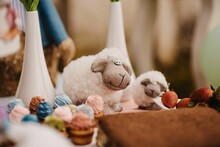 Closeup Of Fluffy Sheep Toys On A Decorated Table Against The Blurred Background