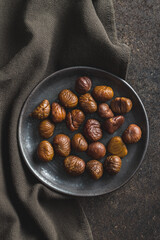 Poster - Peeled chestnuts. Sweet roasted chestnuts on  plate. Top view.