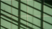 Shadows Cast On Vintage Green Tile In Bathroom 