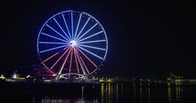USA Pride Colors Flashing From Ferris Wheel On Waterfront Pier