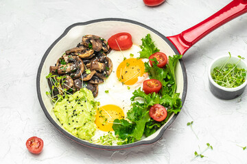 Canvas Print - Fried eggs for breakfast with avocado and mushrooms in a pan, Delicious breakfast or snack, Clean eating, dieting, vegan food concept. top view