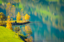 Reflections Of Autumn Trees In Lake Lungern, Obwalden, Switzerland