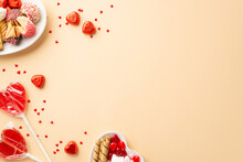 Valentine's Day Concept. Top View Photo Of Heart Shaped Crockery With Sweets Cookies Candies Lollipops And Confetti On Isolated Beige Background With Empty Space