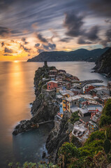 Wall Mural - Vernazza, Cinque Terre, Liguria, Italy - September 2022: A golden sunset in Vernazza. Long exposure picture.