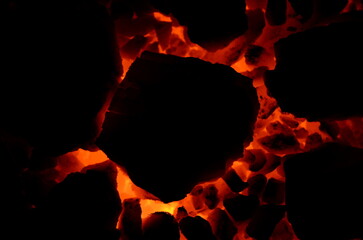 Poster - Dark gloomy graphic resource consists of flaring coal anthracite of large and small fractions.