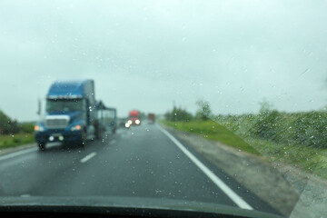 Wall Mural - Blurred view of country road through wet car window. Rainy weather