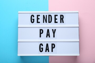 Wall Mural - Lightbox with words Gender Pay Gap on color background, top view