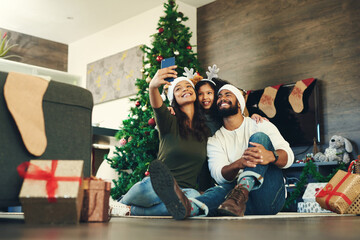 Canvas Print - Family, selfie and celebrating christmas with a man, woman and child excited in a family photo for the festive season. Xmas, gift and mobile picture for social media with parents and kids