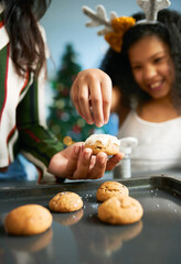 Hands, cookies and baking with a mother and daughter in the kitchen on Christmas for the festive season. Family, children and food with a woman and girl learning hoe to bake together at home