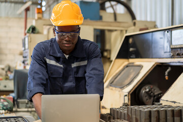 Aufkleber - African American male engineer worker working with laptop computer for control machine in the workshop. Male worker working with lathe machine with safety uniform and helmet in the industry factory