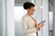 © Rido - African business woman using digital tablet