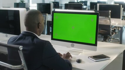 Business African-American Man Working Internet on Computer On Desk. Man Surfing on PC with Green Screen Notebook. Close Up Male Freelancer Searches For Information on The Internet