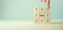 Q And A - An Abbreviation Of Wooden Blocks With Letters On A Gray Background. Illustration For Frequently Asked Questions Concepts In Websites, Social Networks, Business Pages. Business Concept.
