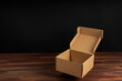 © RooM The Agency - Close-up of an empty open cardboard box on a wooden table