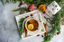 Overhead View Of A  Cup Of Christmas Lemon And Spice Tea With Christmas Decorations On A Table