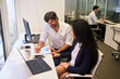 © Robert Kneschke - Consultants and trainees work together on financial analysis
