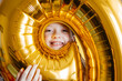 © Анна Молько - a funny smiling girl looks into a golden balloon