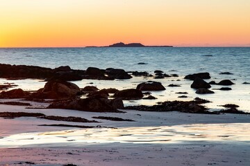 Poster - Beautiful view of the rocky shore and blue sea at sunset. Norway.