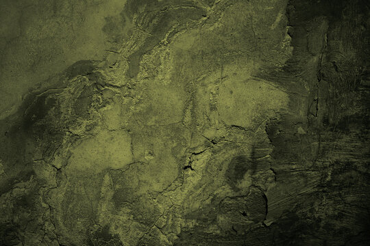 Wall Mural -  - Brown green old concrete wall surface. Dark olive color. Close-up. Rough background for design. Distressed, cracked, broken, crumbled.