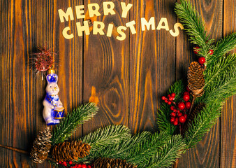 Wall Mural - Christmas wooden background with fir branches and a place to copy.