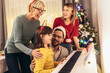© Mediteraneo - Family while enjoying music that their daughter playing on piano during Christmastime