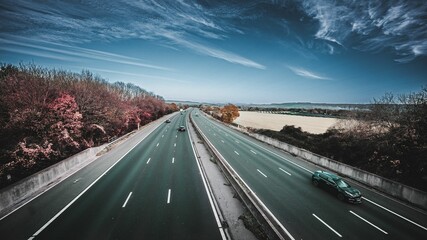 Beautiful shot of a highway with cars under a blue sky