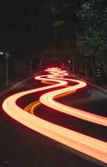Wall Mural - Vertical long exposure shot of the light trails on the road at night