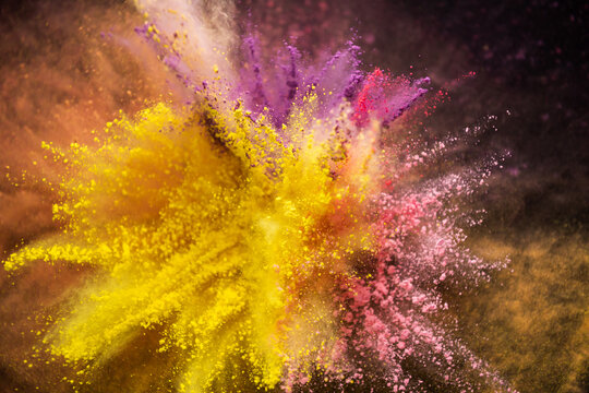 Fototapete - Colored powder explosion isolated on black background
