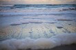Sea foam washing the sandy Paradise Beach in Melbourne Florida