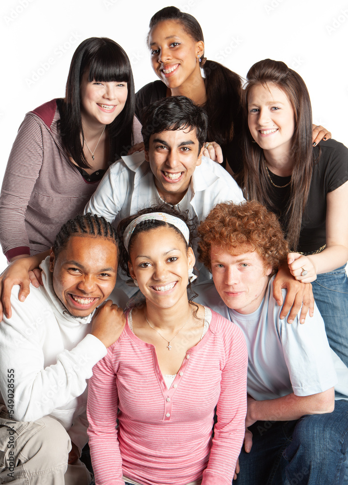 Teenagers: Good Friends. A friendly group portrait of a diverse group of late teenage friends smiling for the camera. From a series of related images.
