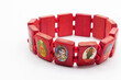 bracelets in red wood with various religious images on a white background