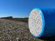 A freshly harvested bale of cotton is wrapped in protective plastic as it awaits shipping.