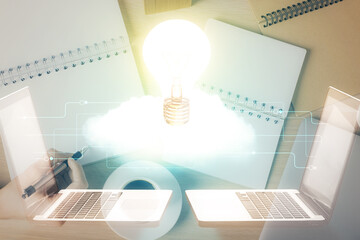 Poster - Bulb hologram over hands taking notes background. Concept of idea. Double exposure