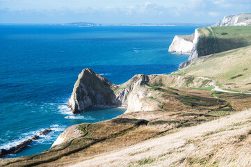 Wall Mural - Beautiful views of nature on way to Durdle door in Lulworth, Dorset, United Kingdom. Part of Jurassic Coast World Heritage Site, view of stone formations and sea, selective focus