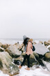 © Photocreo Bednarek - Couple trekking in winter by the sea.