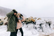 © Photocreo Bednarek - Couple trekking in winter by the sea.