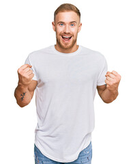 Wall Mural - Young irish man wearing casual clothes celebrating surprised and amazed for success with arms raised and open eyes. winner concept.