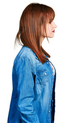 Poster - Redhead young woman wearing casual denim jacket looking to side, relax profile pose with natural face with confident smile.