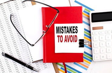 Poster - MISTAKES TO AVOID text on sticky on red notebook on the chart background
