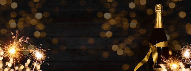 Aufkleber - Sylvester, New Year's Eve 2023 Party, New year, Fireworks, Firework celebration background banner panorama long- Sparklers and champagne or sparkling wine bottle on rustic black wooden wall texture.