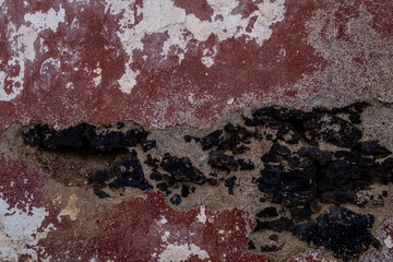 Poster - Old plastered volcanic rock stonework wall with worn out red peeling paint,