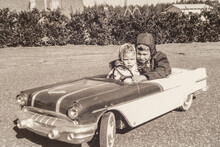 Little Boy And His Sister Driving 1957 Electric Pontiac